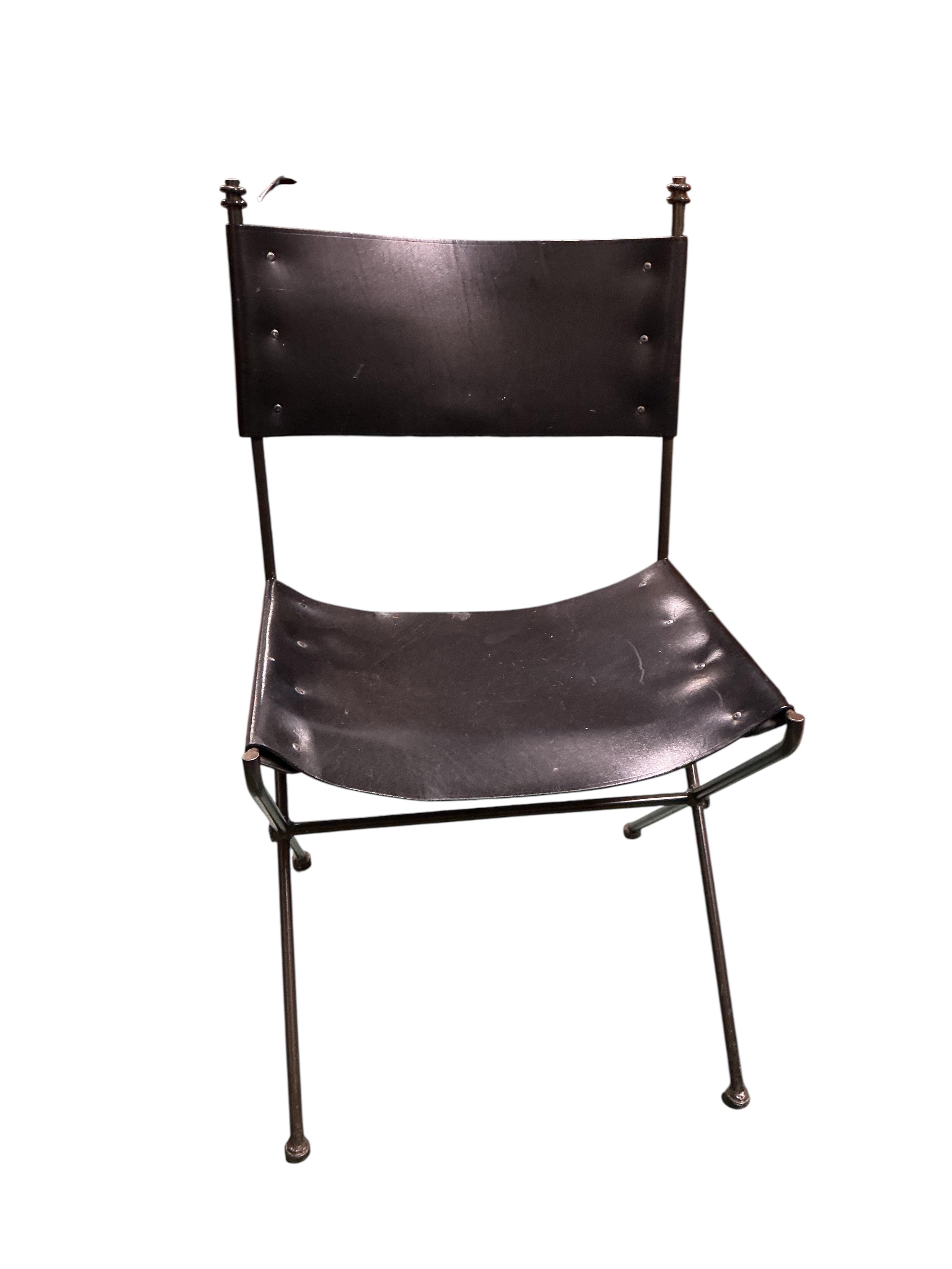 A set of seven mid century wrought iron leather chairs with 'X' frame stretchers, two with arms, width 55cm, depth 50cm, height 90cm